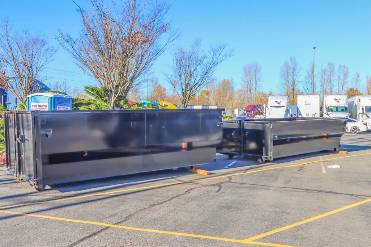 Professional dumpster rental service with roll-off container on residential driveway in North Bergen